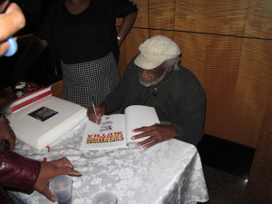 Van Peebles autographs a copy of his book, "Confessions of a Ex-Doofus-ItchyFooted Mutha"